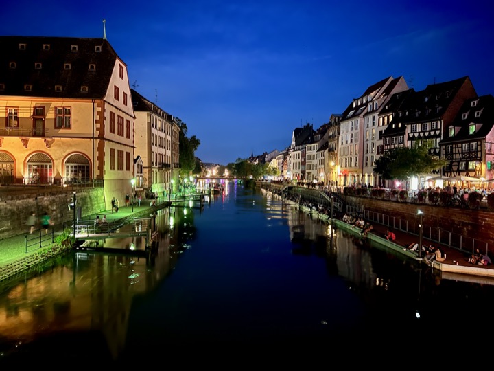 Old-town canal glowing blue and gold at dusk.